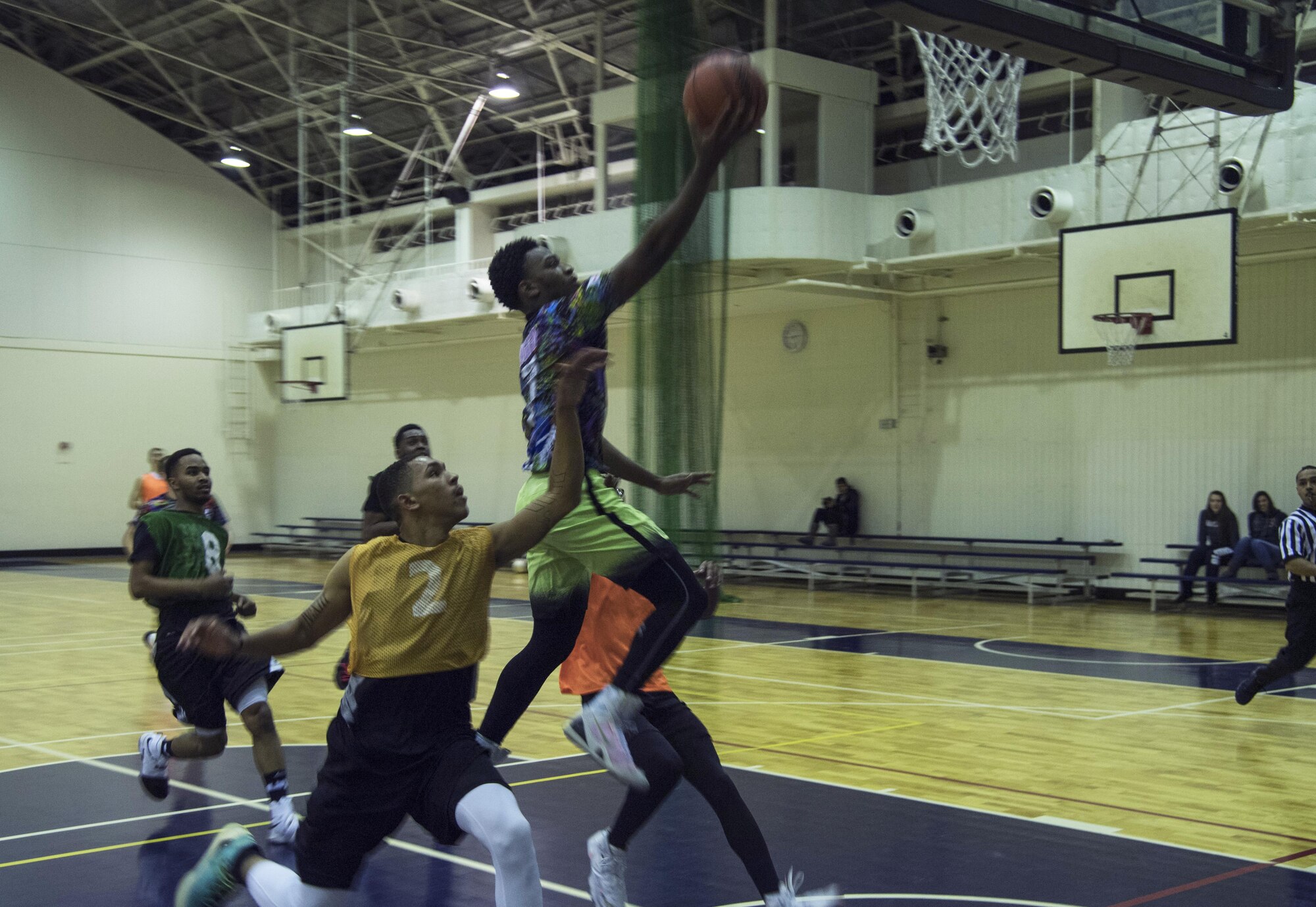 Dalvin James, 374th Maintenance Squadron, goes up for a lay-up during the first half of an intramural basketball game against the 374th Communications Squadron team at Yokota Air Base, Japan, Jan. 24, 2017. James made the shot despite being fouled on the play, but missed the free throw attempt. (U.S. Air Force photo by Staff Sgt. David Owsianka)