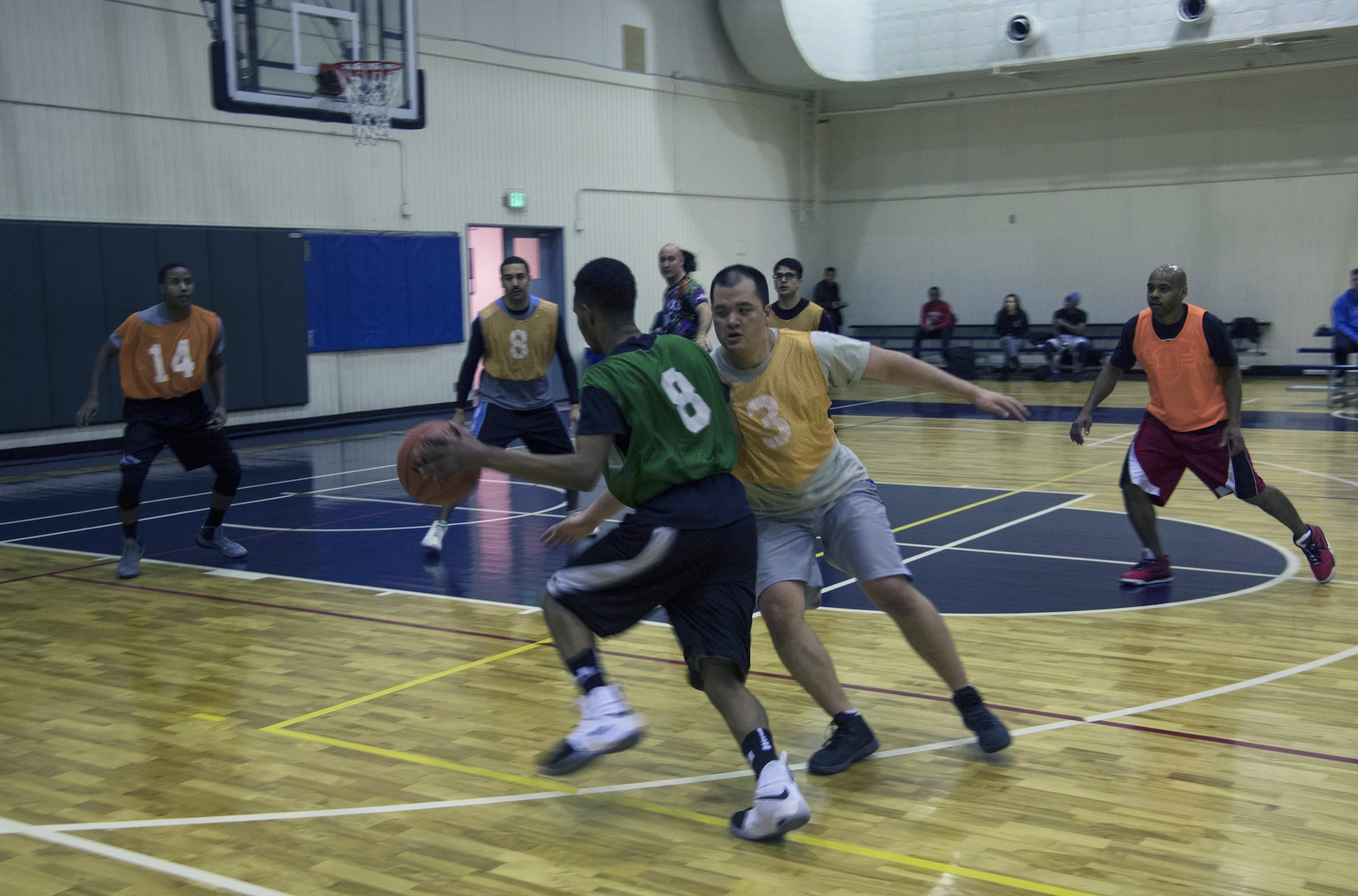 Neiman O’quin, 374th Maintenance Squadron, drives past Joseph Song, 374th Communications Squadron, during the second half of the intramural basketball game at Yokota Air Base, Japan, Jan. 24, 2017. O’quin scored two of his 15 points on this possession, helping the 374 MXS team win 46-40. (U.S. Air Force photo by Staff Sgt. David Owsianka)