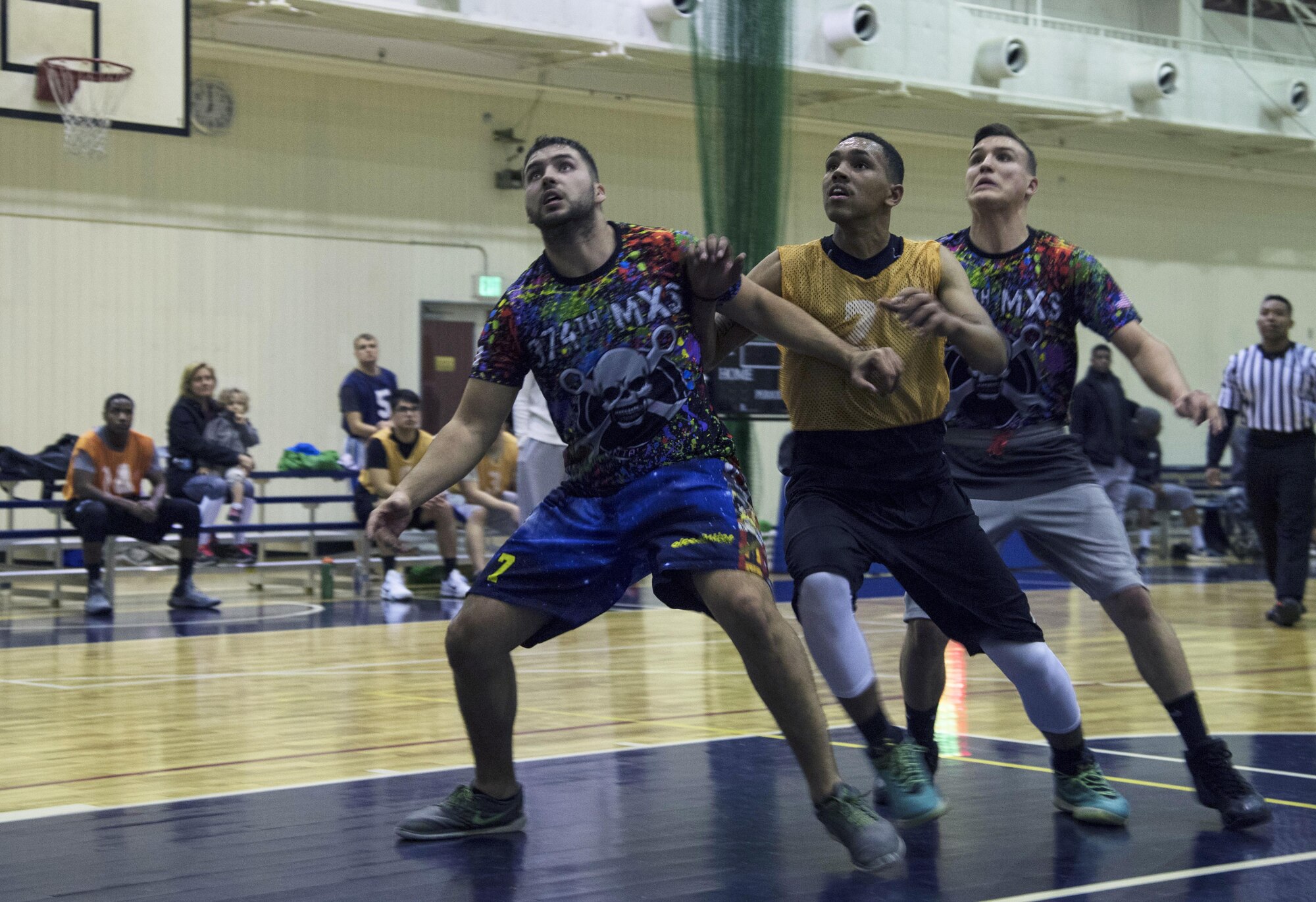 Players from the 374th Maintenance Squadron and 374th Communications Squadron team’s fight to be in a good position for a rebound after a free throw is shot during the second half of the intramural basketball game at Yokota Air Base, Japan, Jan. 24, 2017. A player from the 374 MXS team grabbed the rebound giving them possession. (U.S. Air Force photo by Staff Sgt. David Owsianka)
