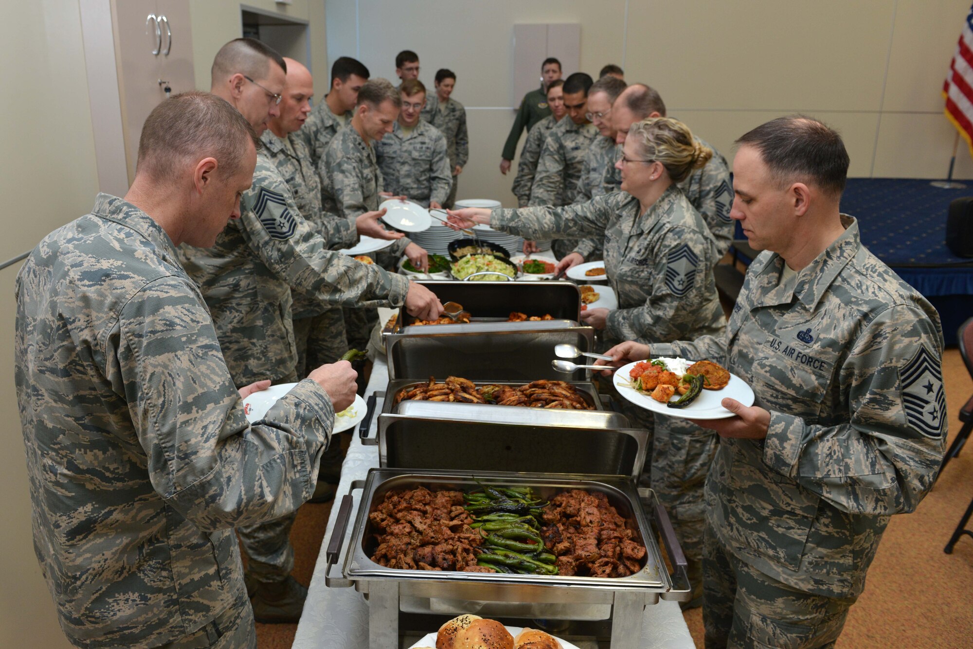 U.S. Airmen attending a spiritual fitness luncheon retrieve food, Jan. 26, 2017, at Incirlik Air Base, Turkey. The event featured special guest Chaplain (Maj. Gen.) Dondi Costin, Air Force chief of chaplains, Turkish food and speakers from the chapel. (U.S. Air Force photo by Senior Airman John Nieves Camacho)