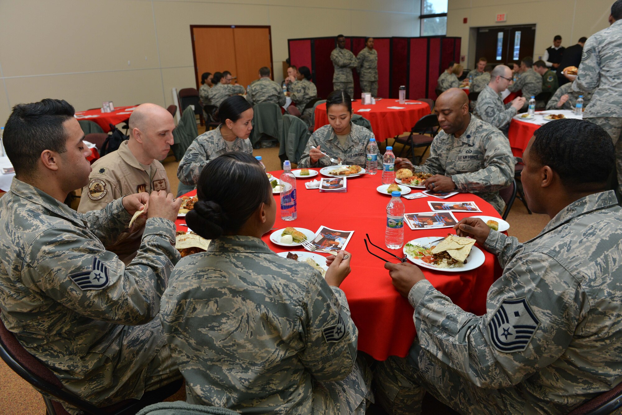 U.S. Airmen attending a spiritual fitness luncheon share a meal together, Jan. 26, 2017, at Incirlik Air Base, Turkey. Guests were treated to Turkish food for lunch including salads, chicken wings and baklava. (U.S. Air Force photo by Senior Airman John Nieves Camacho)