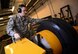 U.S. Air Force Senior Airman Tyler Hyatt, 100th Maintenance Squadron aero repair journeyman, places a tire into a bead breaker Jan. 20, 2017, on RAF Mildenhall, England. The bead breaker breaks two beads which connect the tire and wheel. (U.S. Air Force photo by Senior Airman Christine Halan)
