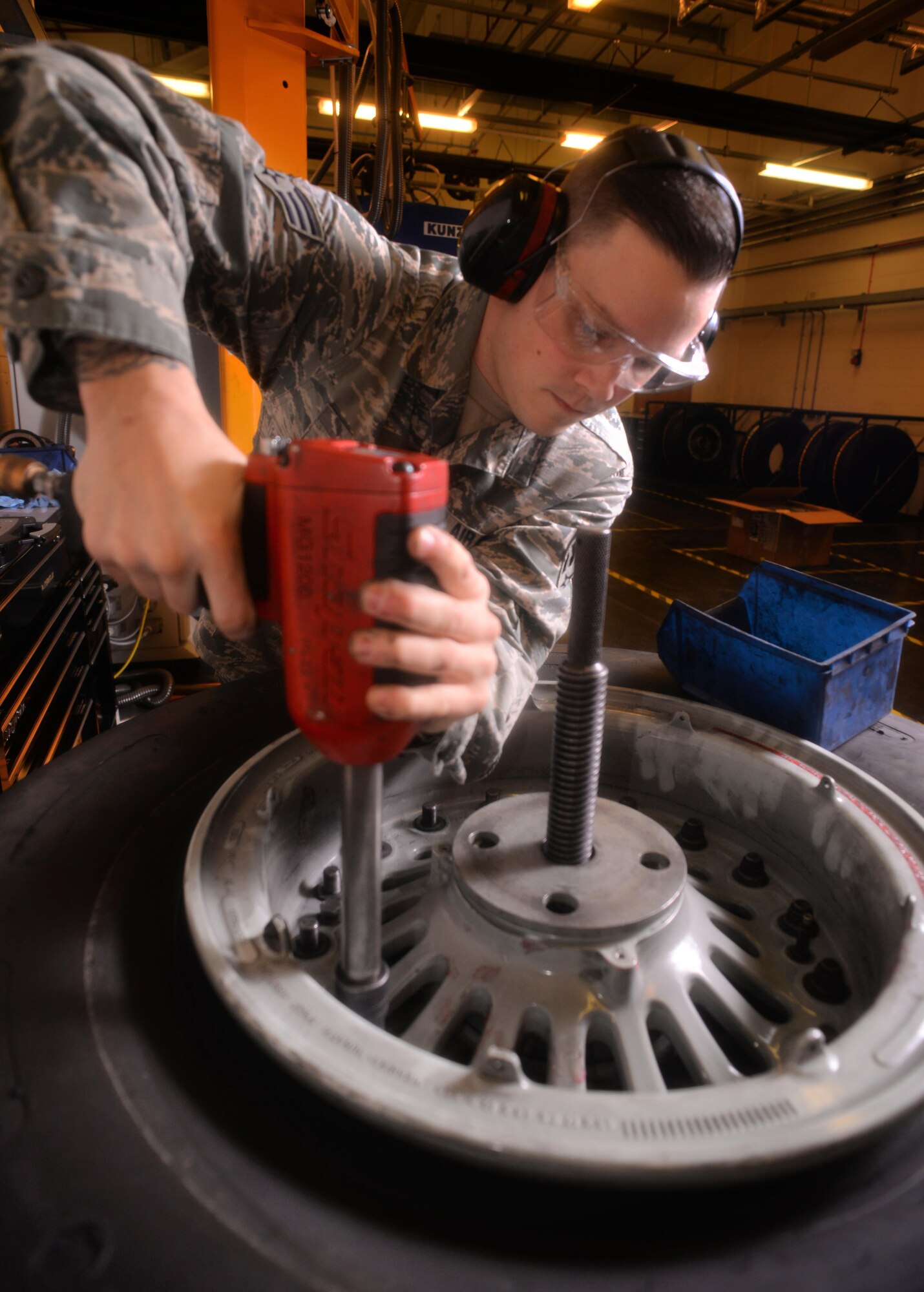 U.S. Air Force Senior Airman Tyler Hyatt, 100th Maintenance Squadron aero repair journeyman, disassembles a wheel and tire assembly with an pneumatic wrench Jan. 20, 2017, on RAF Mildenhall, England. The wheel clamp ensures proper disassembly of the wheel and tire. (U.S. Air Force photo by Senior Airman Christine Halan)