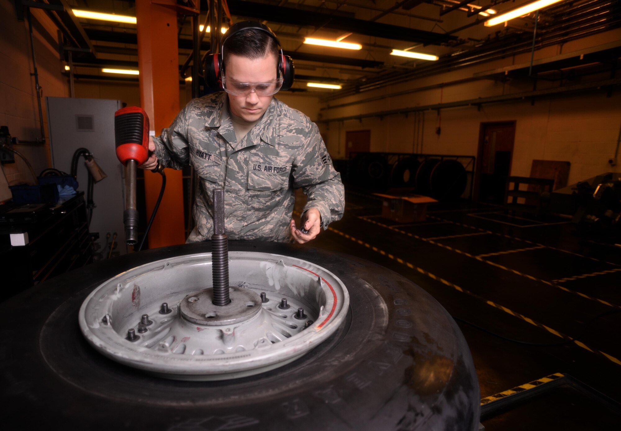 U.S. Air Force Senior Airman Tyler Hyatt, 100th Maintenance Squadron aero repair journeyman, collects and inspects bolts, nuts and washers from a wheel and tire assembly Jan. 20, 2017, on RAF Mildenhall, England. There are more than 50 nuts, bolts and washers joining the assembly together. (U.S. Air Force photo by Senior Airman Christine Halan)