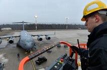Staff Sgt. Zachary Rodewig, 721st Aircraft Maintenance Squadron C-5 Galaxy crew chief, operates a high-reach maintenance platform at Ramstein Air Base, Germany, Jan. 24, 2017. Rodewig and other 721st AMXS mobility Airmen replaced a panel on a C-17 Globemaster III aircraft. The 721st AMXS inspects, repairs, and services all C-17 and C-5 Galaxy aircraft that come through Ramstein. (U.S. Air Force photo by Senior Airman Tryphena Mayhugh)
