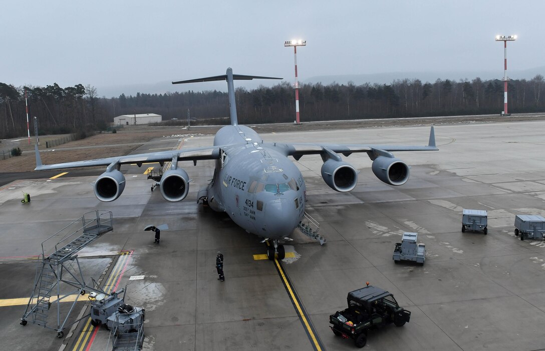 Airmen assigned to the 721st Aircraft Maintenance Squadron work on a C-17 Globemaster III at Ramstein Air Base, Germany, Jan. 24, 2017. The Airmen replaced a panel underneath one of the wings of the aircraft. In one weekend, the 721st AMXS are responsible for more missions than all the other squadrons in the European and Pacific Commands handle in a month combined. (U.S. Air Force photo by Senior Airman Tryphena Mayhugh)
