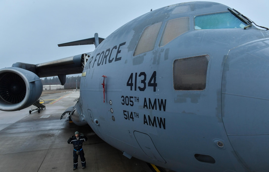 Tech. Sgt. Joey Whatley, 721st Aircraft Maintenance Squadron aircraft propulsion technician, marshals a high-reach maintenance platform up to a C-17 Globemaster III at Ramstein Air Base, Germany, Jan. 24, 2017. On average, the 721st AMXS inspects, services, and repairs 30 aircraft in a single day. The 721st AMXS is part of Air Mobility Command’s 521st Air Mobility Operations Wing. (U.S. Air Force photo by Senior Airman Tryphena Mayhugh)