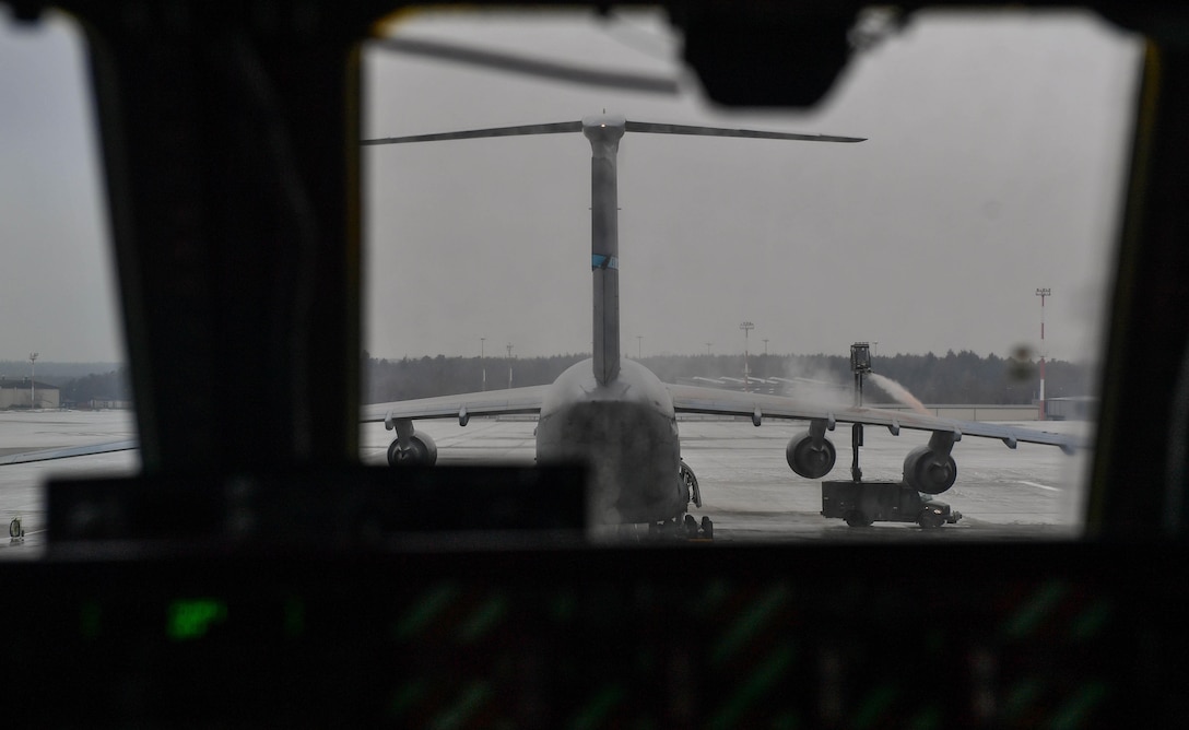 U.S. Air Force Reserve Airmen working with the 721st Aircraft Maintenance Squadron spray propylene glycol onto a C-17 Globemaster III at Ramstein Air Base, Germany, Jan. 24, 2017. The spray was used to deice the aircraft before it departed. In one weekend, the 721st AMXS is responsible for more missions than all the other squadrons in the European and Pacific handle in a month combined. (U.S. Air Force photo by Senior Airman Tryphena Mayhugh)