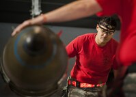 Staff Sgt. Ross Escobar, 23rd Aircraft Maintenance Unit weapons load crew member, guides an inert GBU-31 during the Load Crew of the Quarter competition at Minot Air Force Base, N.D., Jan. 20, 2017. The 23rd and 69th AMU competed in a timed bomb load as a part of the Load Crew of the Quarter competition. (U.S. Air Force photo/Airman 1st Class J.T. Armstrong)