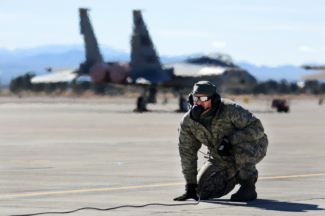 Air National Guard Staff Sgt. Joseph Pollock assists with preflight checks on an F-15 Eagle aircraft before participating in Red Flag 17-1 at Nellis Air Force Base, Nev., Jan. 21, 2017. Pollock is a crew chief assigned to the Florida Air National Guard’s 125th Fighter Wing. Air National Guard photo by Master Sgt. William J. Buchanan