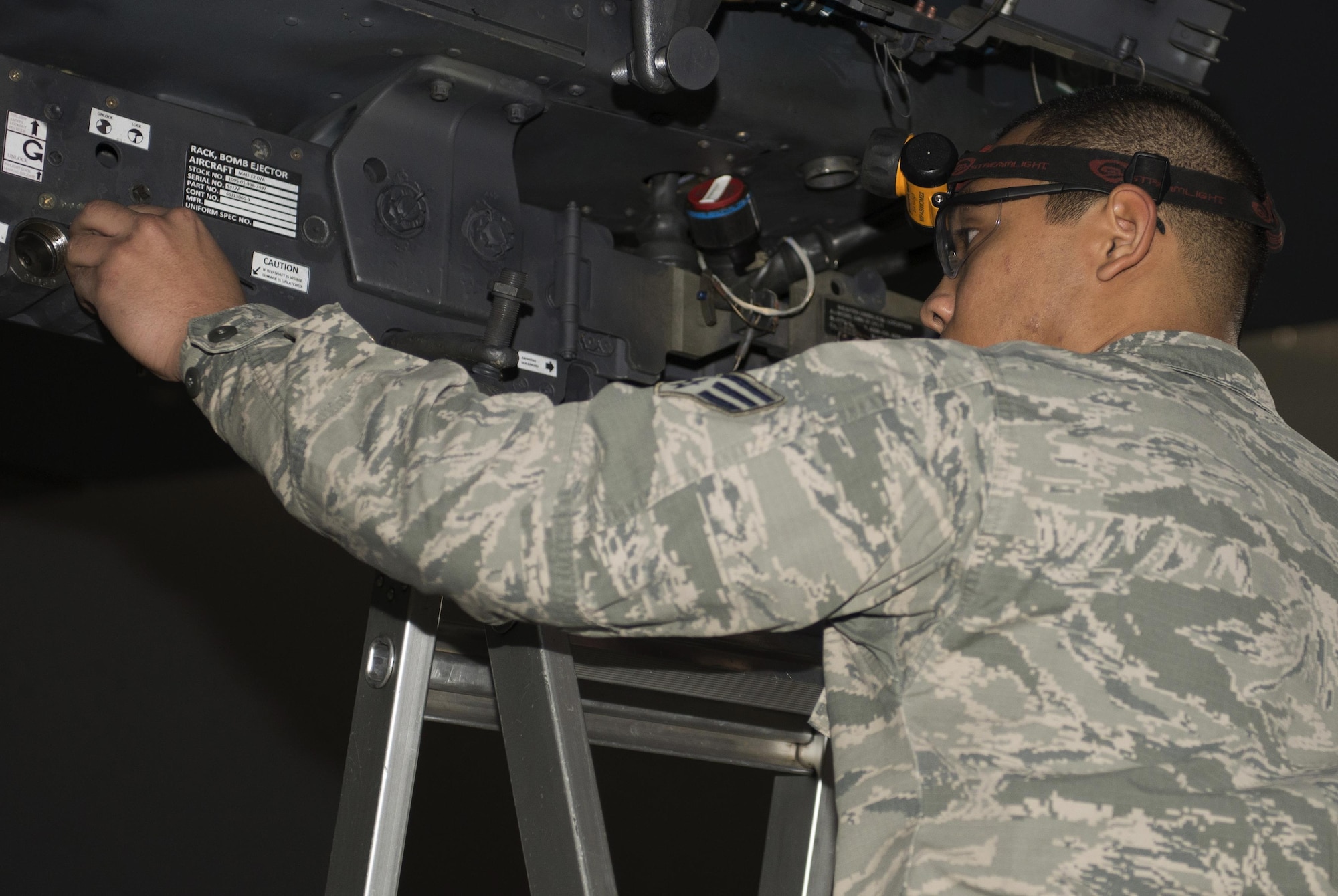 Senior Airman Philip Johnson, 69th Aircraft Maintenance Unit weapons load crew member, prepares a B-52H Stratofortress bomb rack during the 5th Bomb Wing Load Crew of the Quarter competition in Dock 7 at Minot Air Force Base, N.D., Jan. 20, 2017. Representative weapons load crews were made up of teams of four for the competition. (U.S. Air Force photo/Airman 1st Class Alyssa M. Akers)