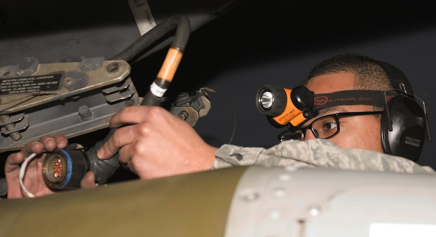 Senior Airman Philip Johnson, 69th Aircraft Maintenance Unit weapons load crew member, locks an inert munition onto a B-52H Stratofortress during the 5th Bomb Wing Load Crew of the Quarter competition in Dock 7 at Minot Air Force Base, N.D., Jan. 20, 2017. The 23rd and 69th AMU competed in a timed bomb load as a part of the Load Crew of the Quarter competition. (U.S. Air Force photo/Airman 1st Class Alyssa M. Akers)