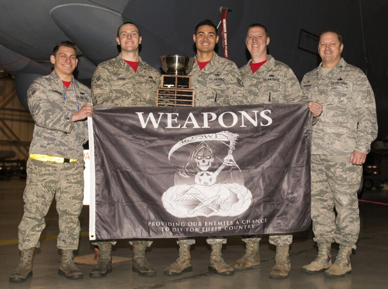 The weapons load crew representing the 23rd Aircraft Maintenance Unit in the 5th Bomb Wing Load Crew of the Quarter competition hold their award for winning the 5th Bomb Wing Load Crew of the Quarter competition in Dock 7 at Minot Air Force Base, N.D., Jan. 20, 2017. The competition was comprised of four parts: dress and appearance, a loader’s knowledge test, toolbox inspection and the timed bomb load. (U.S. Air Force photo/Airman 1st Class Alyssa M. Akers)