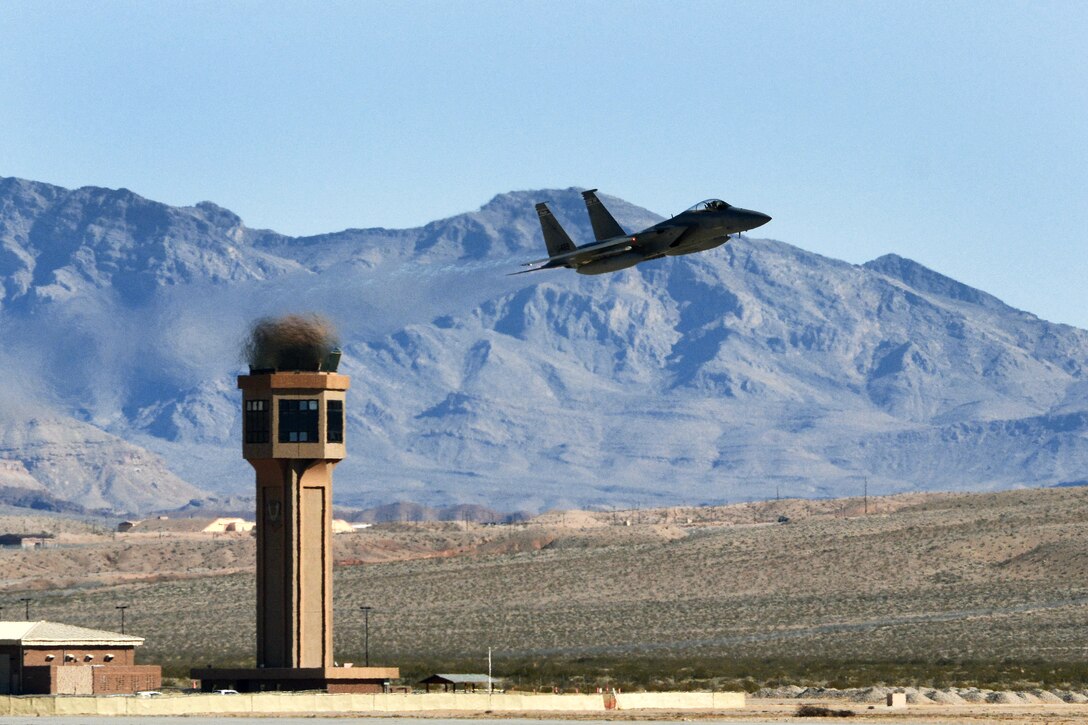 An F-15 Eagle aircraft flies by the traffic tower on a sortie during Red Flag 17-1 at Nellis Air Force Base, Nev., Jan. 21, 2017. Air National Guard photo by Master Sgt. William J. Buchanan