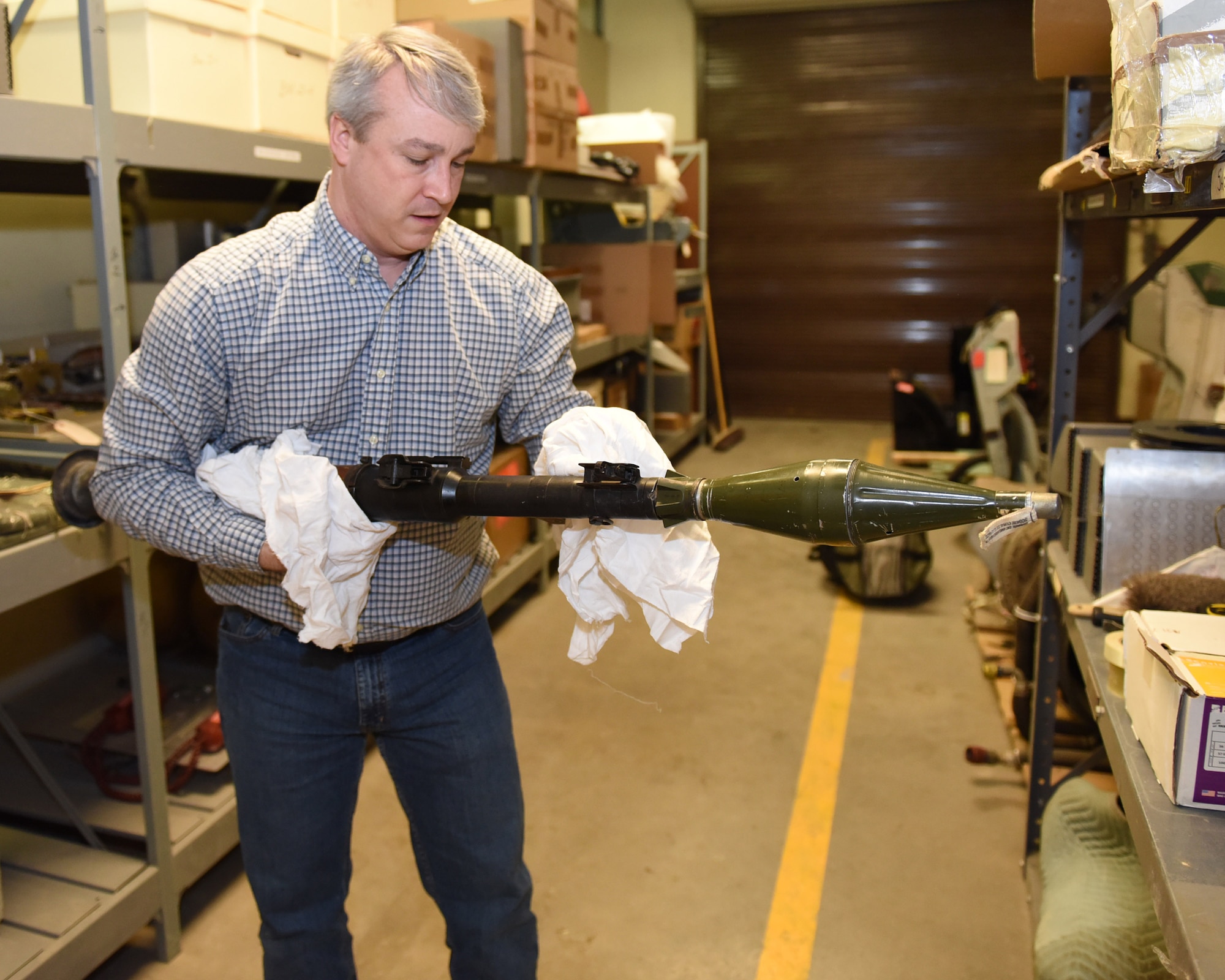 Rob Turnbow, the Malmstrom Historic Exhibit and Air Park curator, takes inventory of a Russian-made rocket-propelled grenade launcher Jan. 26, 2017 at Malmstrom Air Force Base, Mont.  The weapon will eventually become a display piece at the museum.  The museum contains more than 400 items on display that depicts the history of Malmstrom Air Force Base and the Minuteman program.  (U.S. Air Force photo/Jason Heavner)