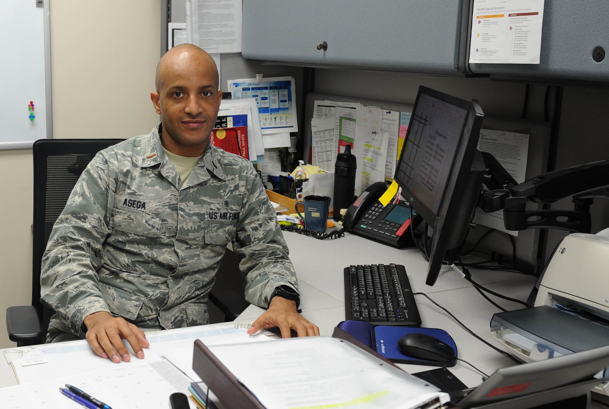 Second Lt. Ashenafi Asega, 22nd Medical Support Squadron TRICARE operations and patient administration flight commander sits at his desk, Nov. 4, 2016, at McConnell Air Force Base, Kan. Asega left Ethiopia to come to the United States when he was 22 years old to pursue an education and later joined the U.S. Air Force. (U.S. Air Force photo/Senior Airman Tara Fadenrecht)