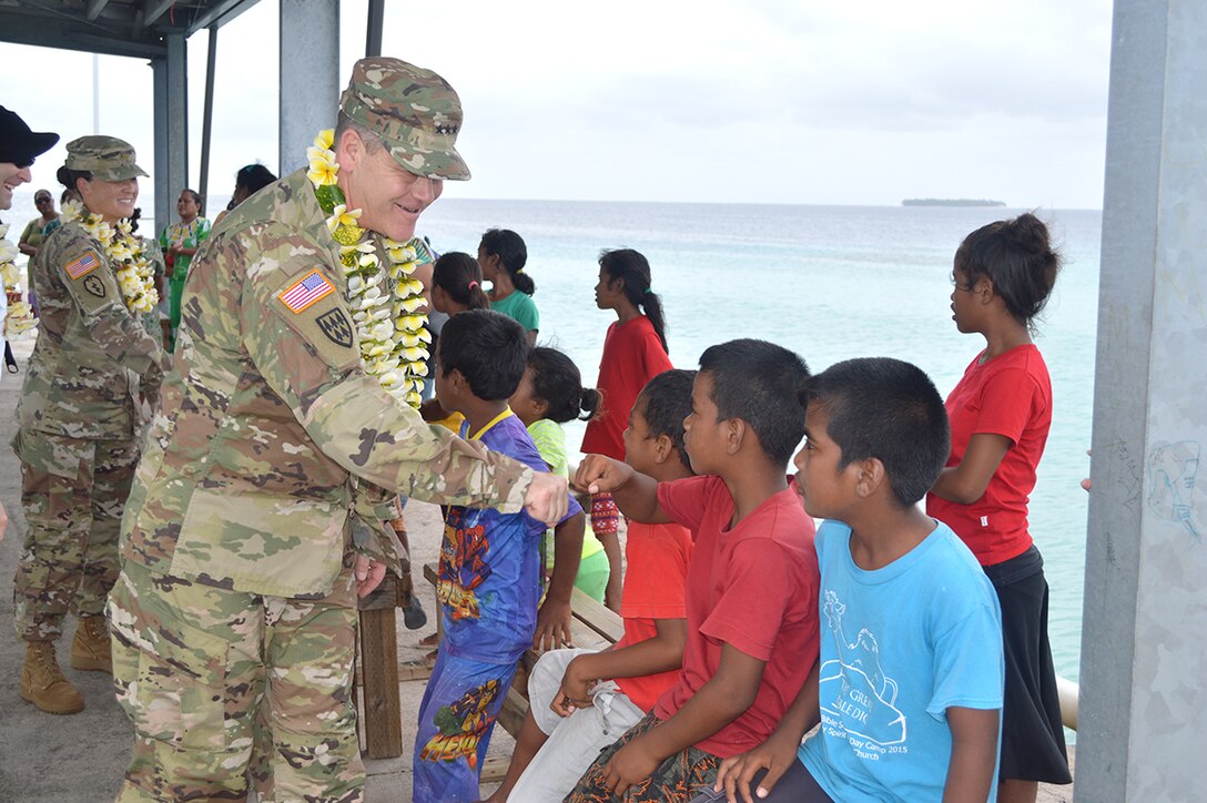 ENNIBURR, Marshall Islands - Children greet Lt. Gen. James Dickinson, commanding general, U.S. Army Space and Missile Defense Command/Army Forces Strategic Command, on the dock during his arrival to the island of Enniburr, Jan. 17, 2017. This was Dickinson's first trip to the Republic of the Marshall Islands since assuming command of SMDC Jan. 5. He visited Marjuro, Roi-Namur, Kwajalein Atoll and Ebeye and visited a number of SMDC, as well as garrison assets, that are located in the Marshall Islands. (U.S. Army photo by Lira Frye)