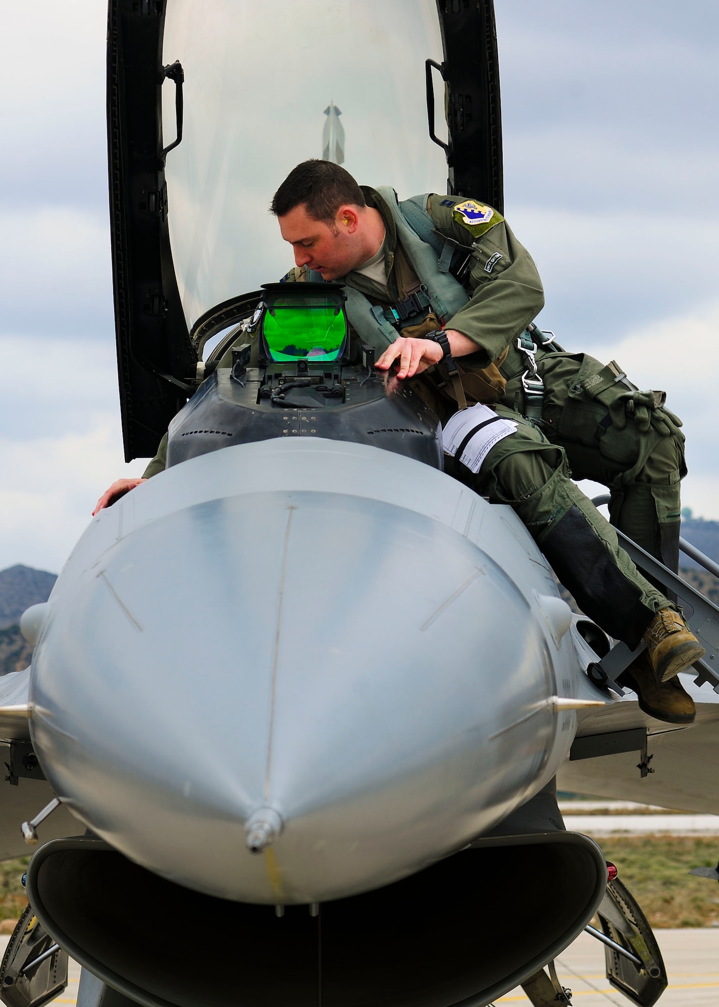 Capt. Kirk Devine, 555th Fighter Squadron F-16 Fighting Falcon pilot from Aviano Air Base, Italy prepares to enter his jet cockpit during a flying training deployment at Souda Bay, Greece on Jan. 23, 2016. Fourteen Aviano F-16s, one KC-135 Stratotanker from the Arizona Air National Guard’s 161st Air Refueling Wing and 280 Airmen deployed to Souda Bay to train with Greece’s Hellenic air force for the two week FTD, scheduled from Jan. 20 to Feb. 3. (U.S. Air Force photo by Staff Sgt. Austin Harvill)