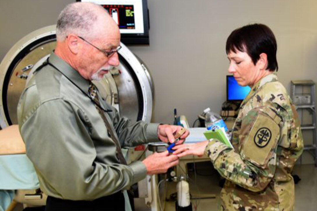 U.S. Army Institute of Surgical Research senior scientist Victor Convertino, Ph.D., demonstrates the functions and capabilities of the Compensatory Reserve Index to Maj. Gen. Barbara Holcomb, commander of the U.S. Army Medical Research and Material Command. Photo courtesy Dr. Steven Galvan