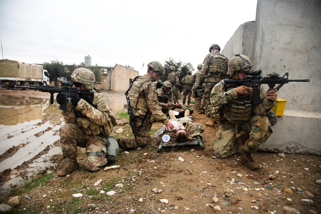 Army paratroopers provide security while medics assist several simulated casualties during medical evacuation training at Camp Swift in Makhmour, Iraq, Jan. 22, 2017. Army photo by Spc. Ian Ryan