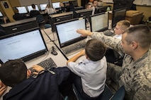 Maj. Trevor Cook, ICBM Systems Directorate Cyber Division deputy chief, mentors cadets at the Utah Military Academy, Riverdale, Utah, Jan. 5. UMA is one of over 3,000 teams participating in CyberPatriot IX. The cybersecurity competition kicked off in October 2016 and the national finals will take place in March. (U.S. Air Force photo by Paul Holcomb)