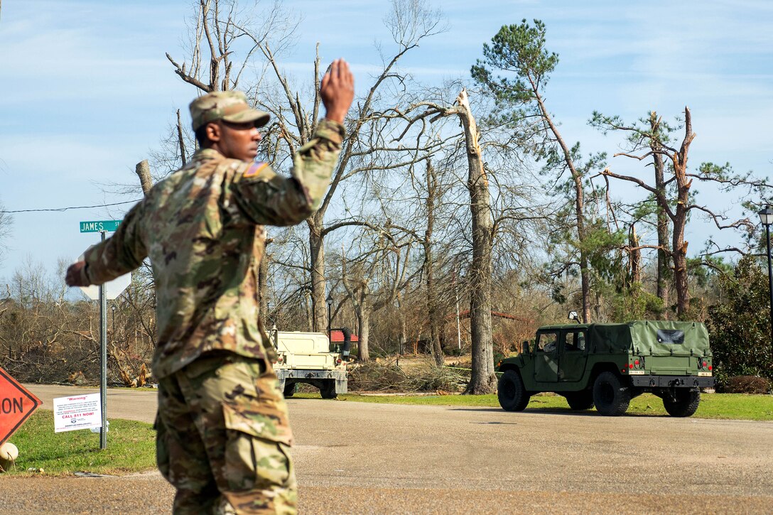 A soldier directs traffic in Hattiesburg, Miss., Jan. 26, 2017, while assisting local law enforcement authorities with disaster relief efforts in the aftermath of a tornado. The soldier is assigned to the Mississippi Army National Guard’s 3656th Maintenance Company, 184th Sustainment Command. Army National Guard photo by Staff Sgt. Tim Morgan