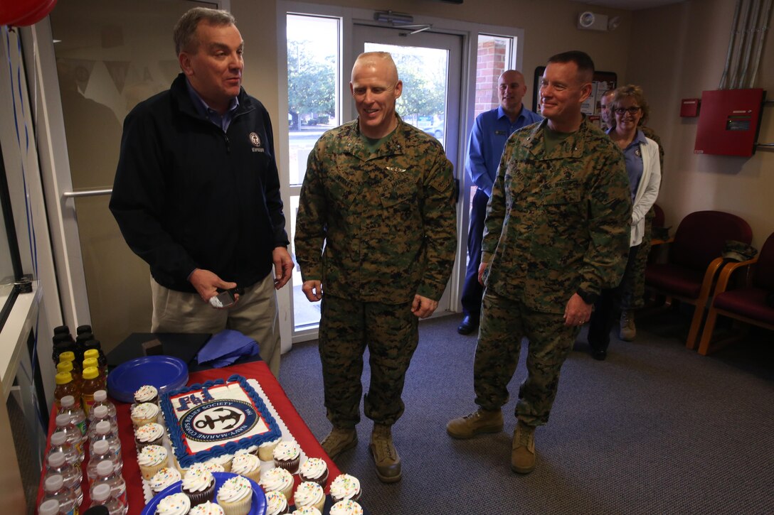 From left to right David Collins with the assistance of Brig. Gen. Thomas Weidley and Brig. Gen. David Maxwell cut the cake for the Navy-Marine Corps Relief Society’s 113th birthday at Marine Corps Base Camp Lejeune’s Navy-Marine Corps Relief Society, Jan. 23. The society provides financial and educational assistance for active duty, retired service members and their dependents. David Collins is the executive vice president for the Navy-Marine Corp Relief Society. Weidley is the commanding general for Marine Corps Installations East – Marine Corps Base Camp Lejeune. Maxwell is the commanding general for 2nd Marine Logistics Group, 2nd Marine Expeditionary Force. (U.S. Marine Corps photo by Lance Cpl. Tavairus Hernandez)