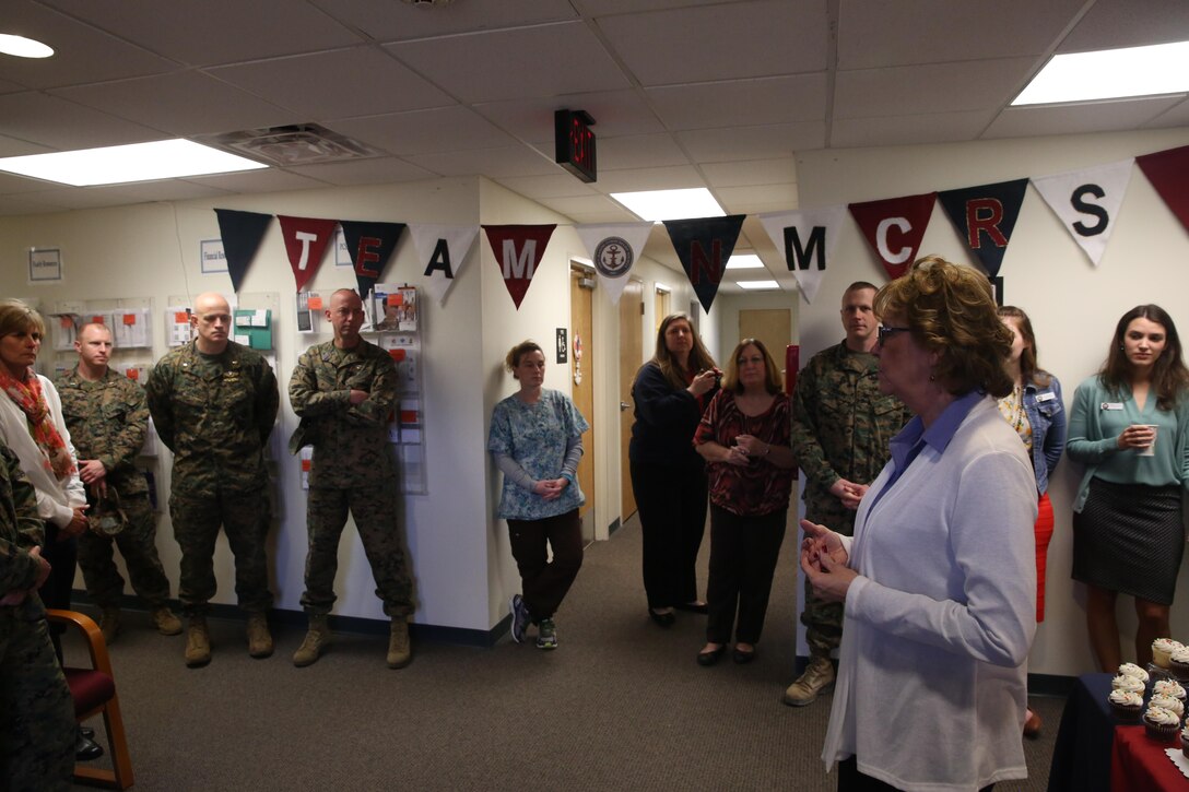 Rita Fountain congratulates the Marines, Sailors, employees and volunteers of the Navy-Marine Corps Relief Society on their 113th birthday at Marine Corps Base Camp Lejeune’s Navy-Marine Corps Relief Society, Jan. 23. The society provides financial and educational assistance for active duty, retired service members and their dependents. Fountain is the director for the Navy-Marine Corps Relief Society on Camp Lejeune. (U.S. Marine Corps photo by Lance Cpl. Tavairus Hernandez)