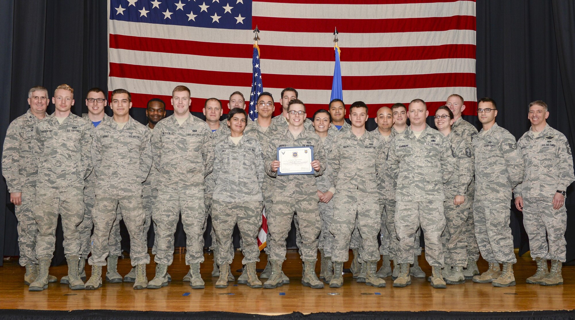 Airmen assigned to 22nd Operations Support Squadron Aircrew Flight Equipment pose for a photo during an award ceremony, Jan. 13, 2017, at McConnell Air Force Base, Kan. The flight was recognized as a team with the 2016 U.S. Air Force AFE Outstanding Large Program Award. (U.S. Air Force photo/Senior Airman Colby Hardin)