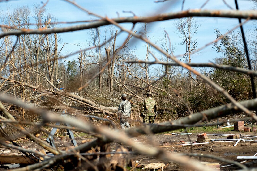 National Guard soldiers search through debris and fallen trees while supporting disaster relief efforts in Hattiesburg, Miss., Jan. 26, 2017, following a tornado. Army National Guard photo by Staff Sgt. Tim Morgan