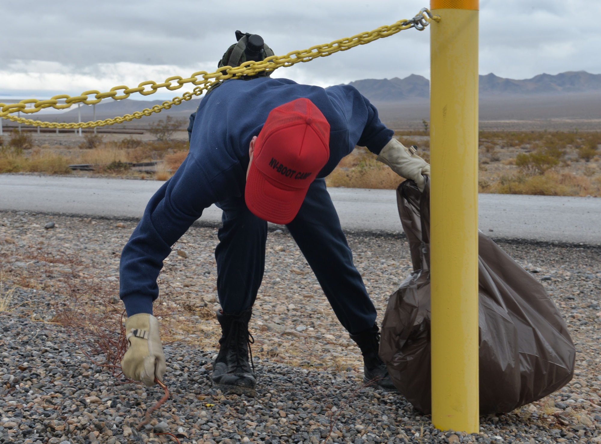 A Three Lakes Valley Boot Camp inmate performs manual labor near Creech Air Force Base, Nev., Jan. 13. The 799th Security Forces Squadron and the State of Nevada Department of Corrections, TLVBC have a cooperative agreement/outreach program and has already conducted four range clean up and mentorship sessions along with two PT sessions. 