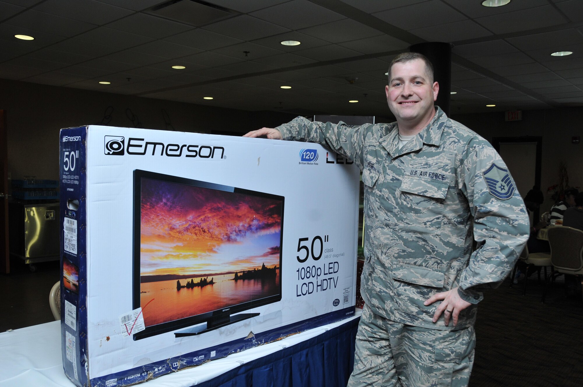 Master Sgt. James Pegg, 910th Force Support Squadron Services Supervisor, claims his prize after winning a 50-inch TV at the Community Activity Center here Jan. 8, 2017. The TV was donated to benefit service members by a local store and given away through a free raffle conducted by the 910th Community Sustainment Services Flight. (U.S. Air Force photo/Staff. Sgt. Rachel Kocin)