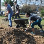 Petty Officers 1st Class Lori Estess (left), from Naval Health Clinic Corpus Christi-San Antonio Detachment, or NHCCC SA DET, and Mari Williams from Navy Medicine Education, Training and Logistics Command, or NMETLC, shovel fresh mulch into a wheelbarrow during a community relations at Patrolman Guadalupe Martinez Park in San Antonio. NHCCC SA DET and the Navy Medicine Education, Training and Logistics Command at Joint Base San Antonio-Fort Sam Houston have a joint Chief Petty Officer 365 program where chiefs and petty officers participate in regular training, physical fitness and community relations opportunities.