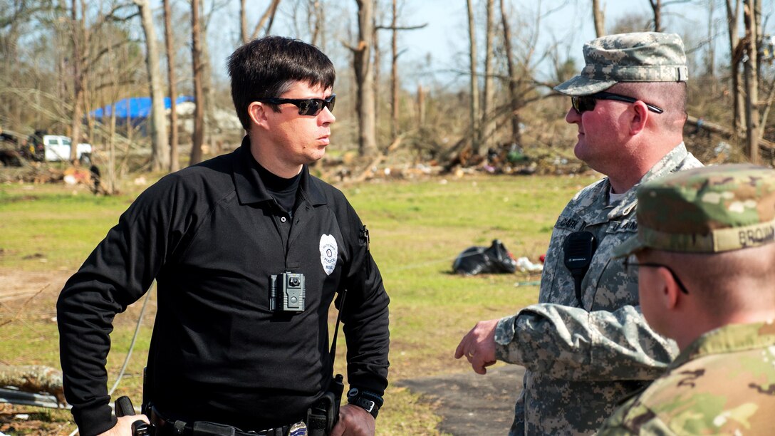 National Guard soldiers talk to a law enforcement officer during disaster relief efforts in Hattiesburg, Miss., Jan. 26, 2017, after a tornado swept through the area. Army National Guard photo by Staff Sgt. Tim Morgan