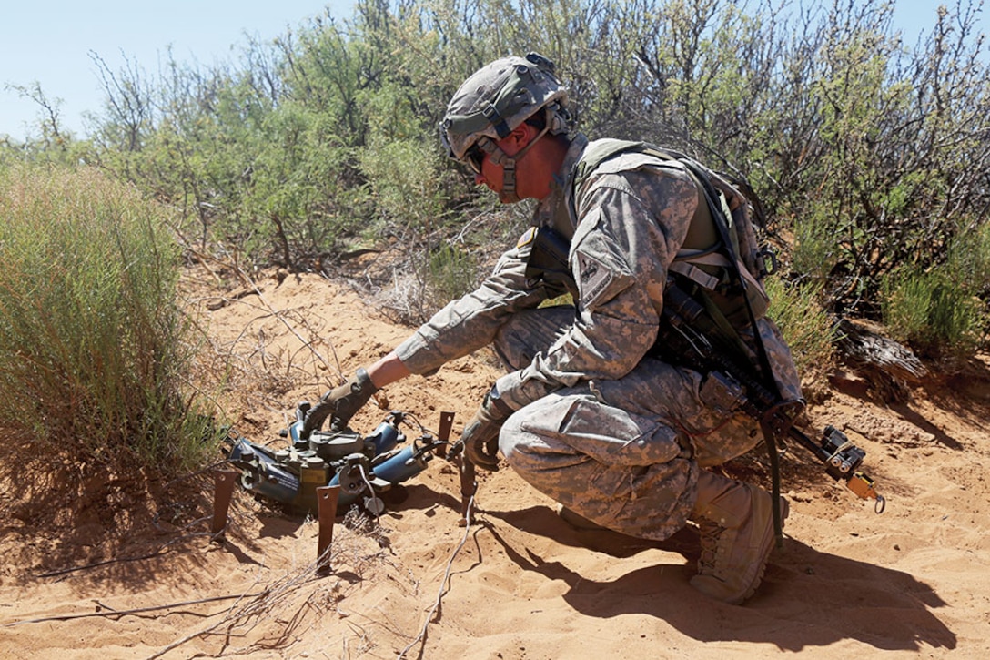 Soldier adjusts M7 Spider Networked Munitions during Network Integration Evaluation 16.2 at training village Kamal Jabul, Fort Bliss, Texas, May 2016