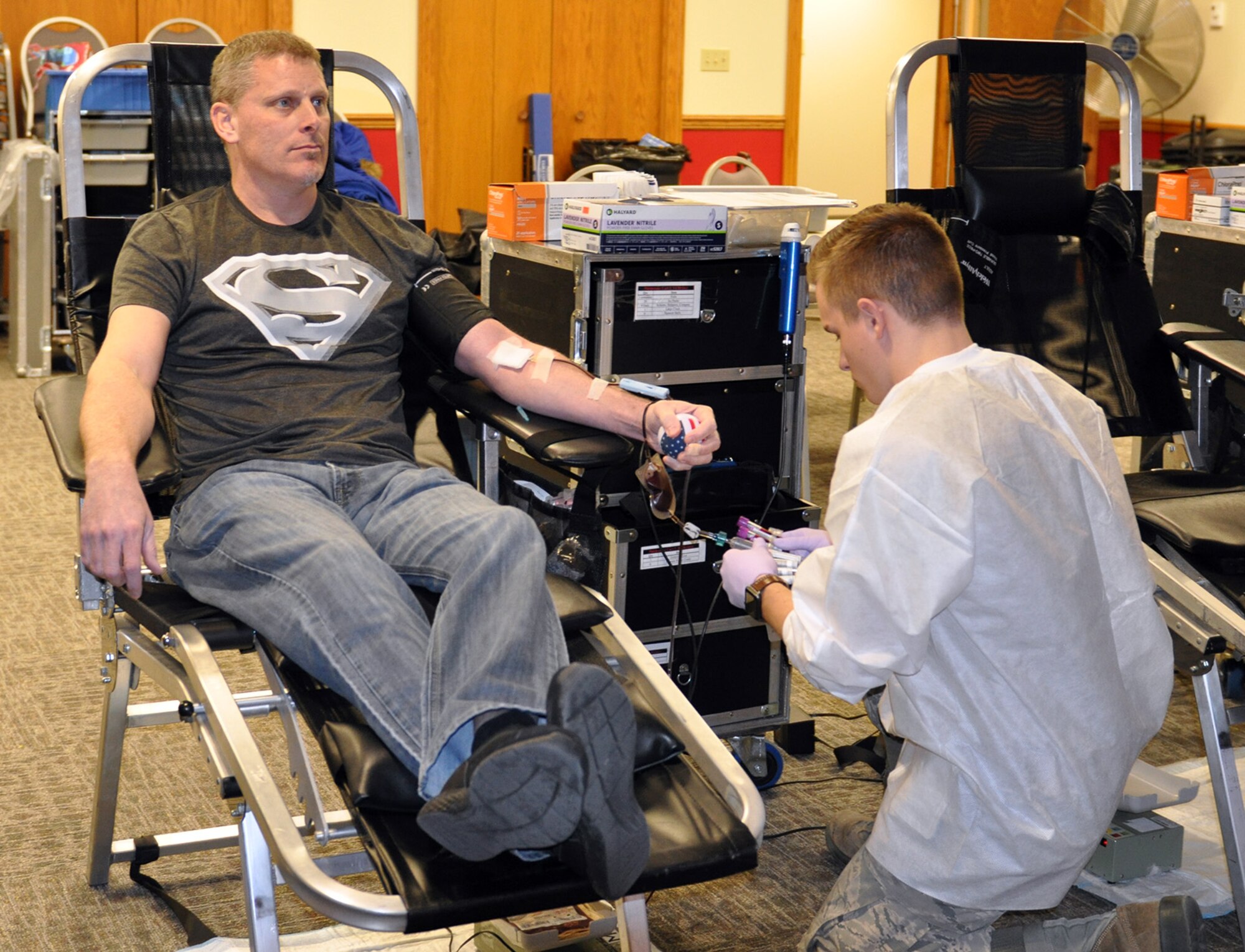 Airman 1st Class Alexander Myers, 88th Air Base Wing Medical Center laboratory technician, takes blood from Tech. Sgt. Michael Benzing, 445th Maintenance Group, plans, scheduling and documentation office, during a blood drive held at the 445th Airlift Wing Jan. 27, 2017. The event was sponsored by the 445th Aerospace Medicine Squadron for the Wright-Patterson Air Force Base Blood Donor Center. Nine units of blood was collected. According to the WPAFB Donor Center, type O blood is 45 percent of all Americans and O positive is 85 percent as compared to O negative. Type O positive can be given to anyone regardless of their blood type and with war-time injuries. One trauma victim may require 40-plus units. One donation can save up to three people. (U.S. Air Force photo/Stacy Vaughn)