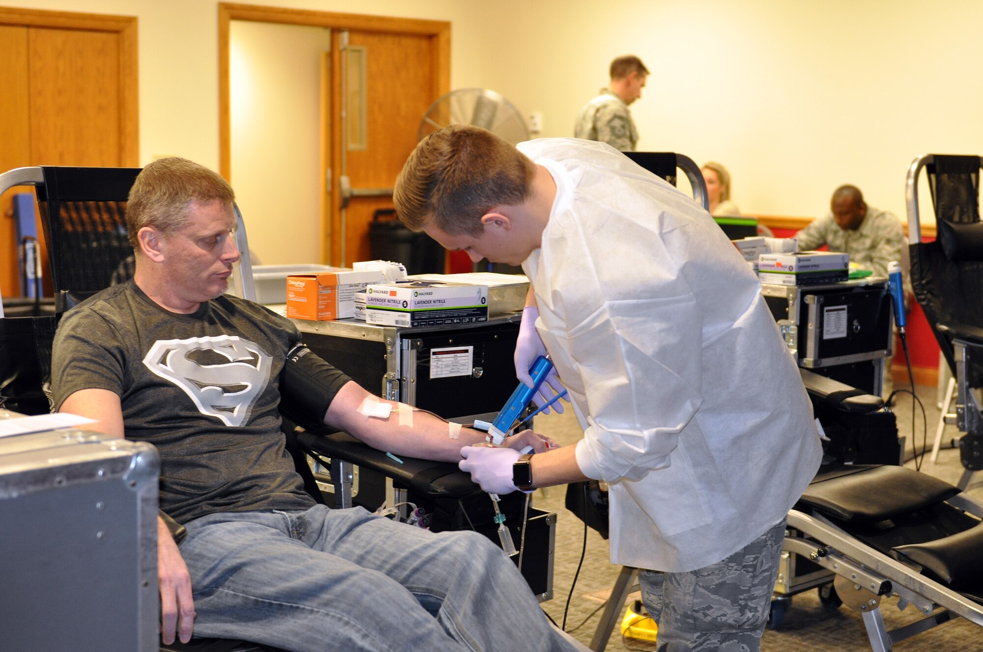 Airman 1st Class Alexander Myers, 88th Air Base Wing Medical Center laboratory technician, prepares to take blood from Tech. Sgt. Michael Benzing, 445th Maintenance Group, plans, scheduling and documentation office, during a blood drive held at the 445th Airlift Wing Jan. 27, 2017. The event was sponsored by the 445th Aerospace Medicine Squadron for the Wright-Patterson Air Force Base Blood Donor Center. Nine units of blood was collected. According to the WPAFB Donor Center, type O blood is 45 percent of all Americans and O positive is 85 percent as compared to O negative. Type O positive can be given to anyone regardless of their blood type and with war-time injuries. One trauma victim may require 40-plus units. One donation can save up to three people. (U.S. Air Force photo/Stacy Vaughn)
