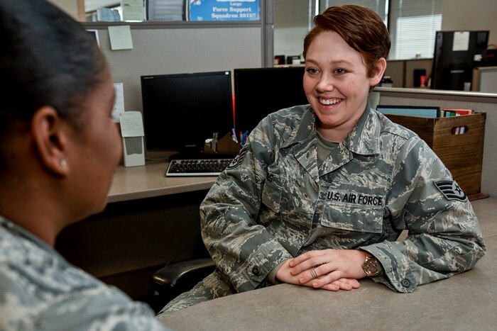Air Force Staff Sgt. Jacquelyn Combs, 21st Force Support Squadron noncommissioned officer-in-charge of customer support at the Peterson Air Force Base, Colo., military personnel section, jokes with a coworker, Nov. 14, 2016. Combs was diagnosed with Crohn’s disease while at her first assignment and diagnosed with cancer at her second assignment, but didn’t let either affliction stop her from doing her best. Air Force photo by Senior Airman Rose Gudex