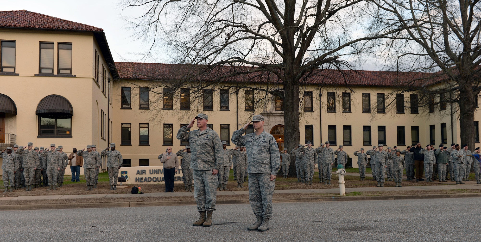 Military members salute the U.S. flag during retreat on Maxwell Air Force Base, Ala., Jan. 26, 2017. During retreat, Airman Leadership School students participated in folding the U.S. flag as part of their daily duty in the five-week course. (U.S. Air Force photo/Senior Airman Tammie Ramsouer)