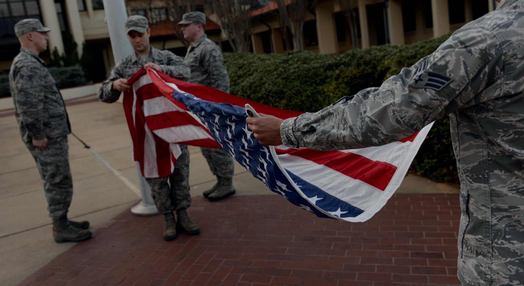Students attending Airman Leadership School, fold the U.S. flag during retreat on Maxwell Air Force Base, Ala., Jan. 26, 2017.  All ALS students participate in reveille and retreat every day as part of their duties during the five-week leadership course. (U.S. Air Force photo/Senior Airman Tammie Ramsouer) 