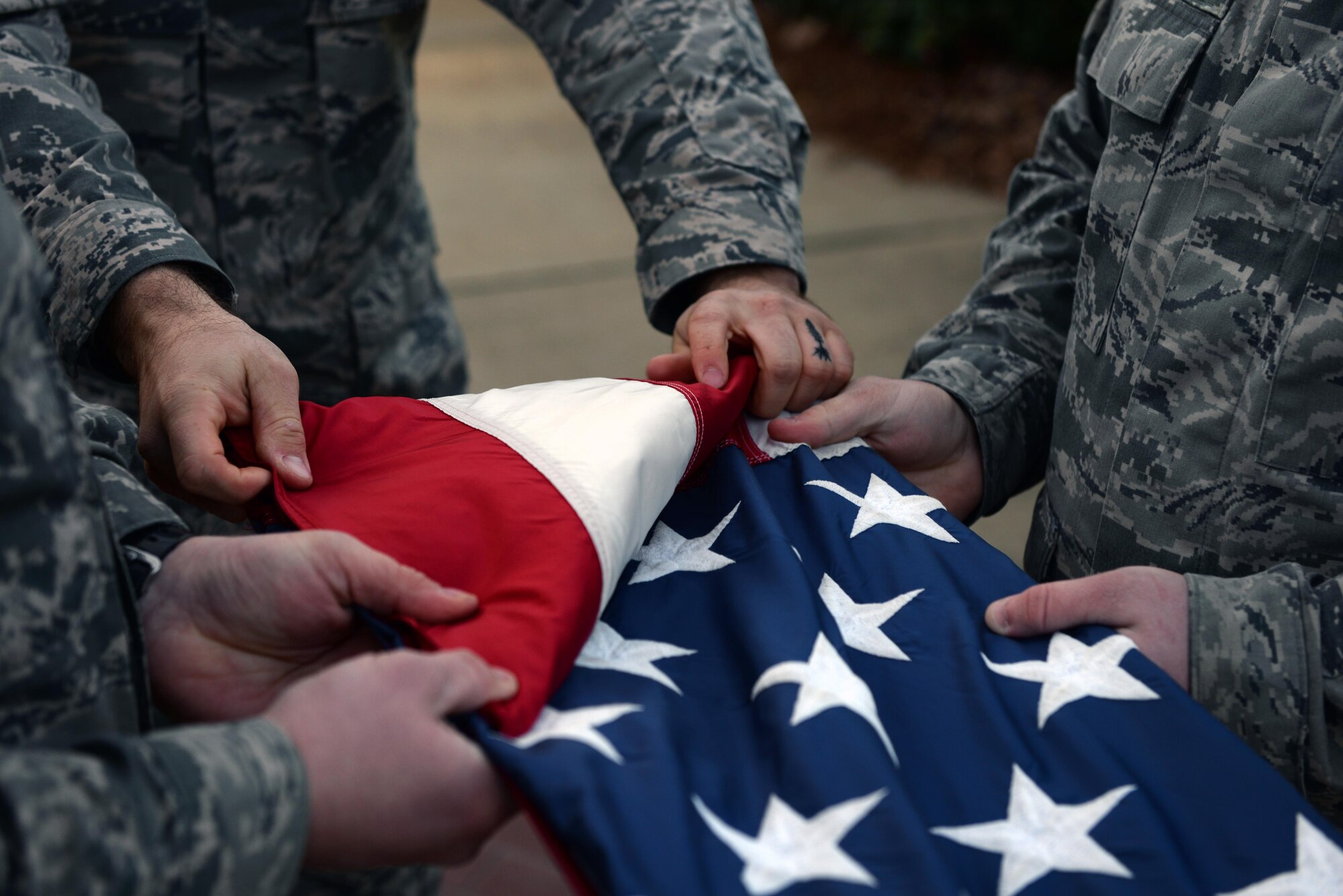 Students from the Airman Leadership School fold the U.S. flag during retreat on Maxwell Air Force Base, Ala., Jan. 26, 2017. All ALS students participate in reveille and retreat every day as part of their duties during the five-week leadership course. (U.S. Air Force photo/Senior Airman Tammie Ramsouer)