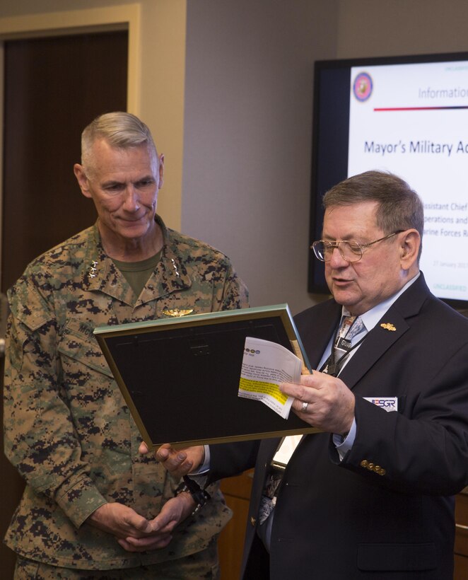 Larry Jones (right), vice chair of Employer Support of the Guard and Reserve, presents Lt. Gen. Rex C. McMillian (left), commander of Marine Forces Reserve and Marine Forces North, with the Seven Seals Department of Defense Award at Marine Corps Support Facility New Orleans, Jan. 27, 2017. The award was given to McMillian for his leadership and initiative in support of the men and women who serve in the Reserve. (U.S. Marine Corps photo by Sgt. Ian Leones)