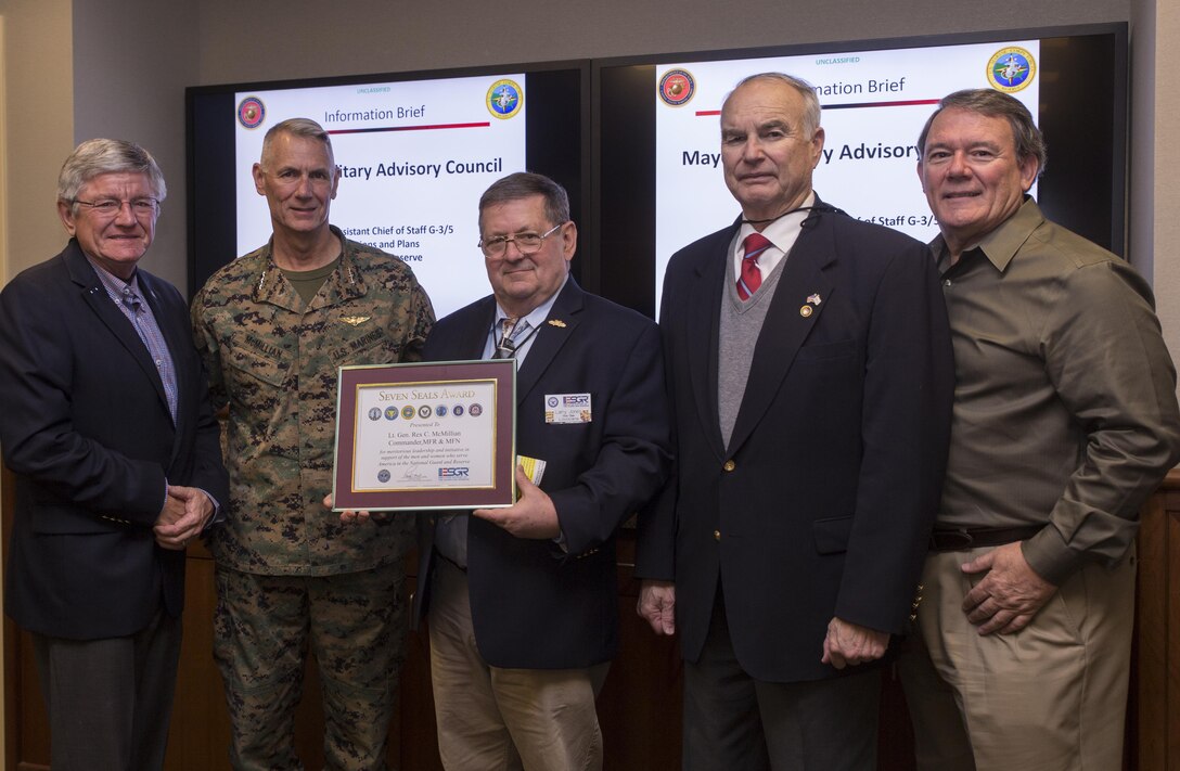 Lt. Gen. Rex C. McMillian (second from left), commander of Marine Forces Reserve and Marine Forces North, receives the Seven Seals Department of Defense Award from members of Employer Support of the Guard and Reserve at Marine Corps Support Facility New Orleans, Jan. 27, 2017. The award was given to McMillian for his leadership and initiative in support of the men and women who serve in the Reserve. (U.S. Marine Corps photo by Sgt. Ian Leones)
