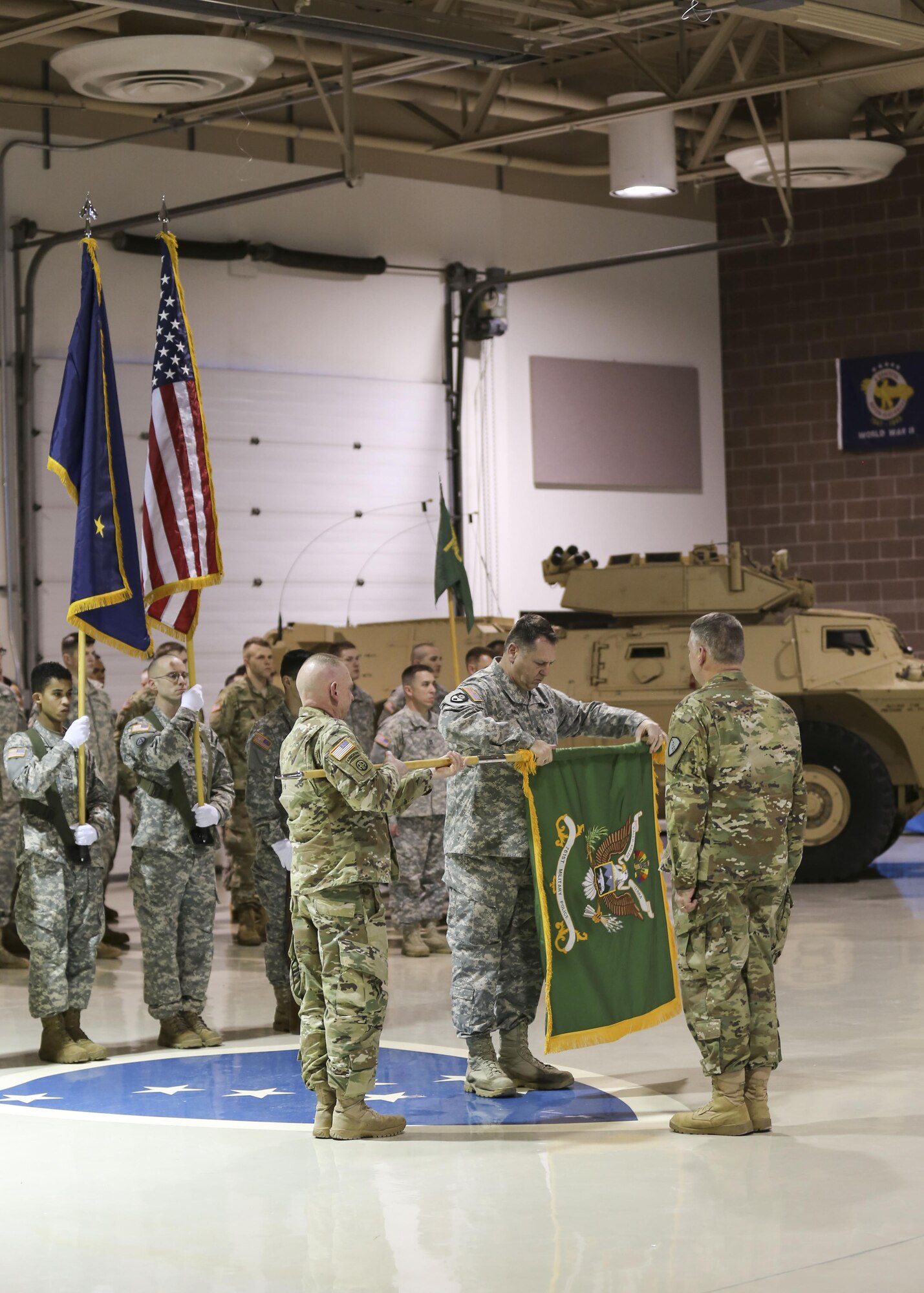 Lt. Col. James Palembas, 761st Military Police Battalion commander, holds the unit colors as Command Sgt. Maj. George Juelch, 761st MP BN command sergeant major, cases the colors signifying the unit's deactivation Jan. 22, 2017, at the Alaska National Guard Armory on Joint Base Elmendorf-Richardson. (U.S. Army National Guard photo by Staff Sgt. Balinda O’Neal Dresel)