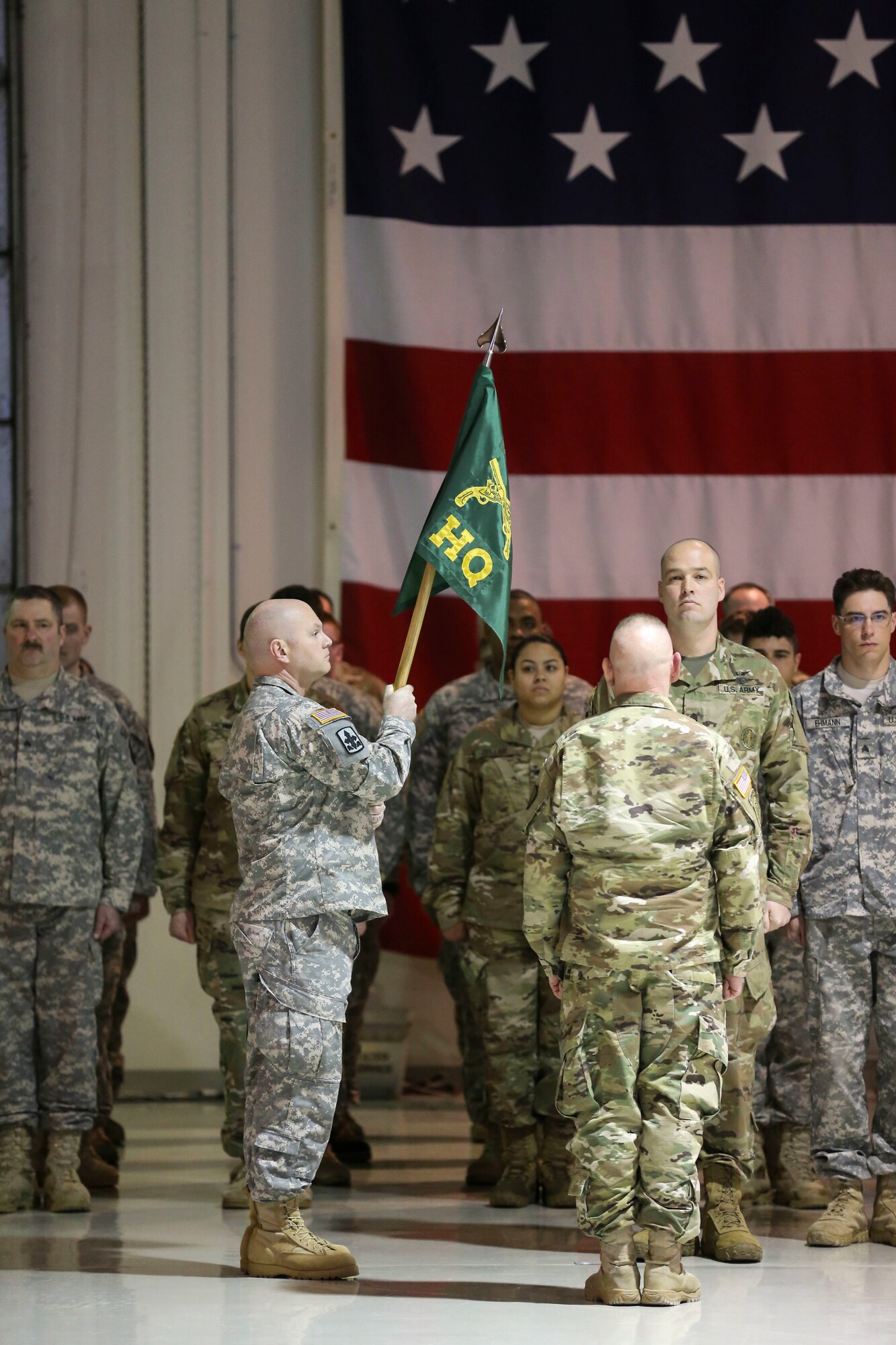 Capt. Eric Kelly, Headquarters and Headquarters Detachment, 761st Military Police Battalion, begins lowering the unit colors in preparation of casing signifying the unit's deactivation Jan. 22, 2017, at the Alaska National Guard Armory on Joint Base Elmendorf-Richardson. (U.S. Army National Guard photo by Staff Sgt. Balinda O’Neal Dresel)