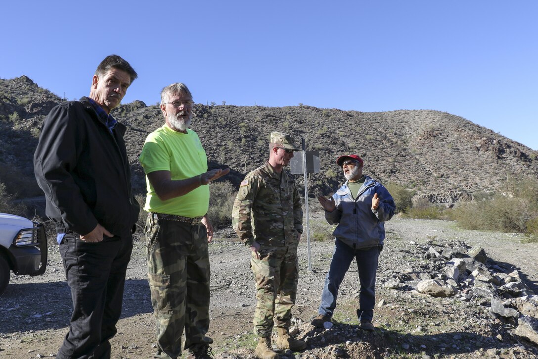 James Boyd, a dam operator at Alamo Dam, briefs John Keever (left), chief of the Construction Division Jan. 25. The dam provides flood risk reduction, water supply and conservation, recreation, and fish and wildlife enhancement on the Bill Williams River.