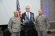 From left, Maj. Gen. Garret Harencak, Air Force Recruiting Service commander,  presents the American Spirit Award to Dan Clark Jan. 26, 2017 at the Air Force Recruiting Service Leadership Conference in San Antonio.  At right is Chief Master Sgt. Brian LaBounty, AFRS command chief.  Since 1980, the AFRS award has been presented to civilians who have made a significant impact on Airmen and the Air Force. (U.S. Air Force photo by Joel Martinez)