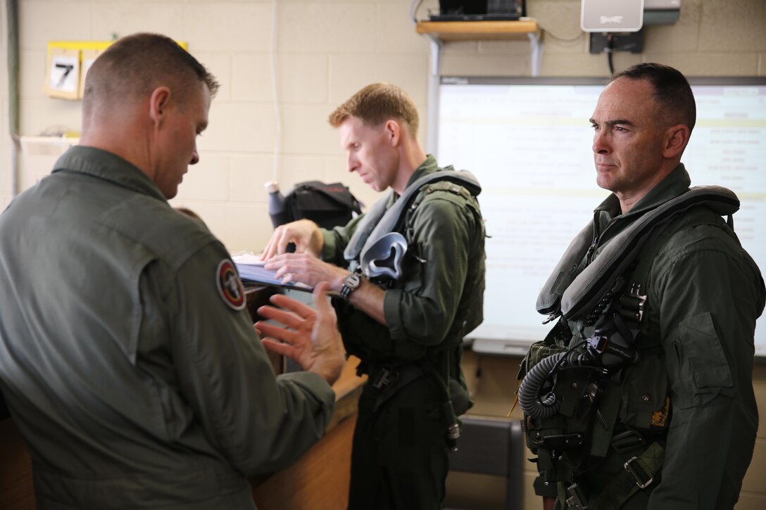 Maj. Gen. John Love, right, 2nd Marine Division commanding general, speaks with Col. John Rahe during a visit to Marine Attack Training Squadron 203, Marine Aircraft Group 14, 2nd Marine Aircraft Wing  aboard Marine Corps Air Station Cherry Point, Jan. 27, 2017. During his visit, Love was able to witness the capabilities of an AV-8B Harrier firsthand as he strapped in and took his first career flight in the aircraft. Love’s visit strengthened the relationship between the ground and air combat elements of the Marine Air-Ground Task Force. Rahe is the assistant wing commander for 2nd MAW. (U.S. Marine Corps photo by Lance Cpl. Cody Lemons/Released)