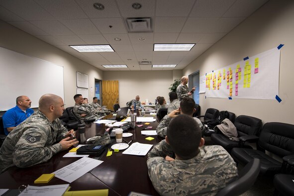 Representatives from Air Combat Command discuss every step to disassembling, repairing and reassembling the TF-34 engine used in A-10C Thunderbolt lls, Jan. 23, 2017, at Moody Air Force Base, Ga., during a Continuous Process Improvement event. After systematically breaking down every step, members provided ideas to potentially make the processes more efficient. (U.S. Air Force photo by Airman 1st Class Daniel Snider)