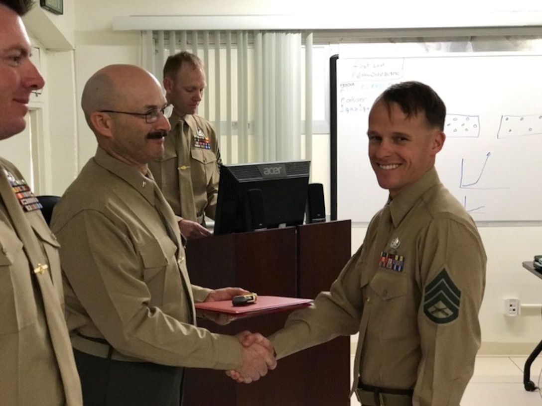 The Explosive Ordnance Disposal Advanced Training Center (EODATC) recently graduated Ordnance Exploitation Class 2017010.    Staff Sergeant Christopher F. Williams from MWSS-373, the class honor graduate, receives his certificate from CWO5 Kelly J. Colton the EODATC Director.                

